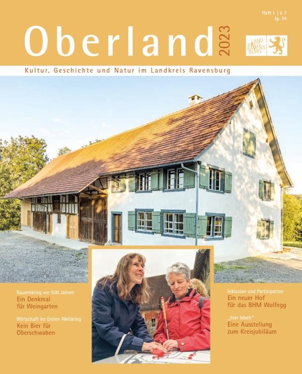 Das neue "Oberland" Titelblatt des Magazins Oberland. Darauf ein Bild des Bauernhofes Beck, darunter ein Bild mit zwei weiblichen Personen, die mit den Händen einen plastischen Geländeplan des Museums abtasten.