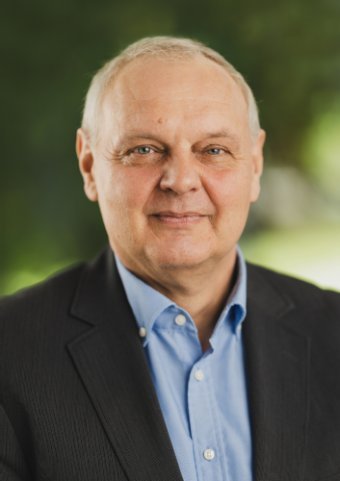 Franz Baur Franz Baur, ein Mann mittleren Alters mit hoher Stirn und weißem kurzem Haar. Er trägt weder Bart noch Brille. Er trägt ein dunkles Jackett und darunter ein hellblaues Hemd.